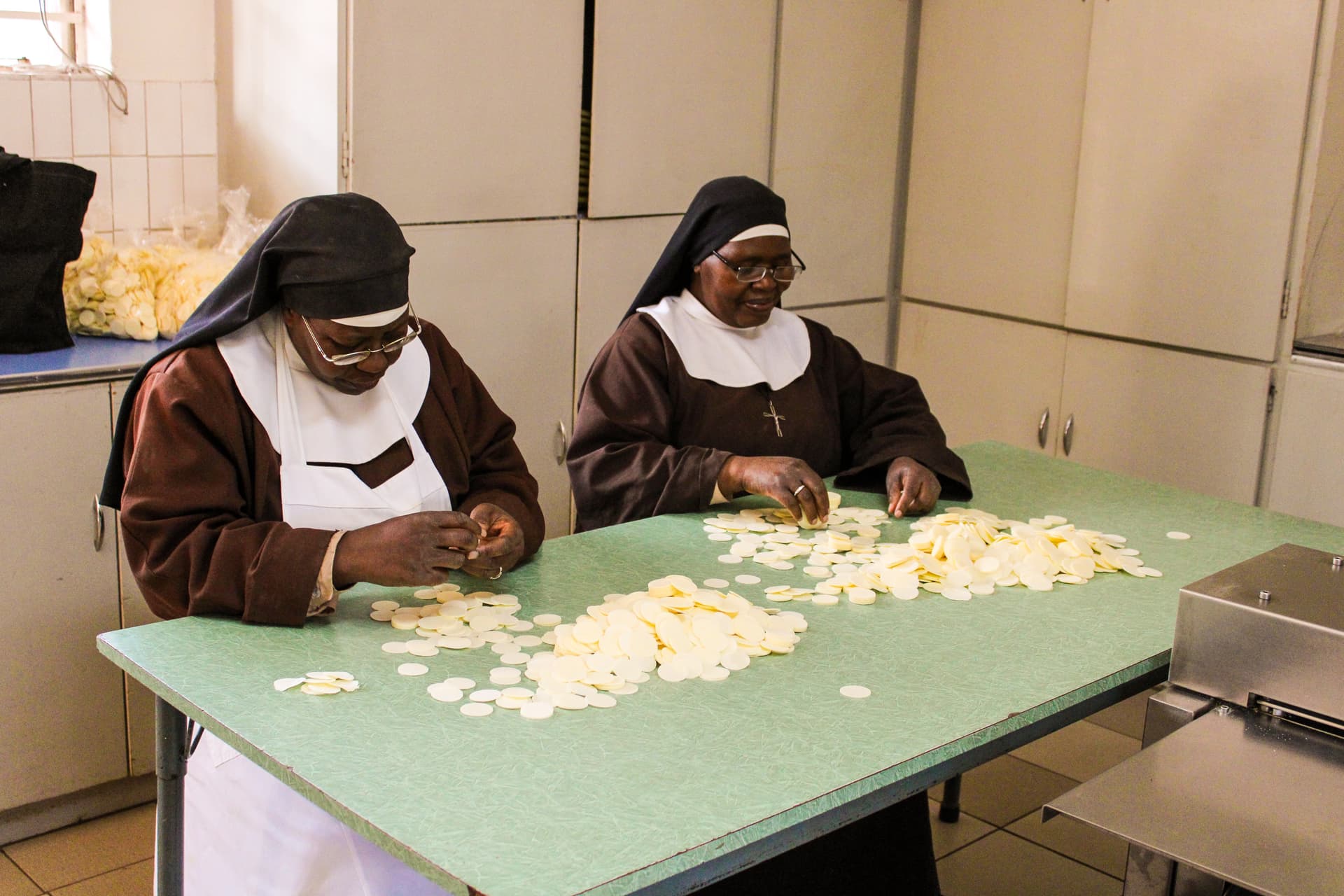 Due sorelle preparano le ostie (© ACN)
